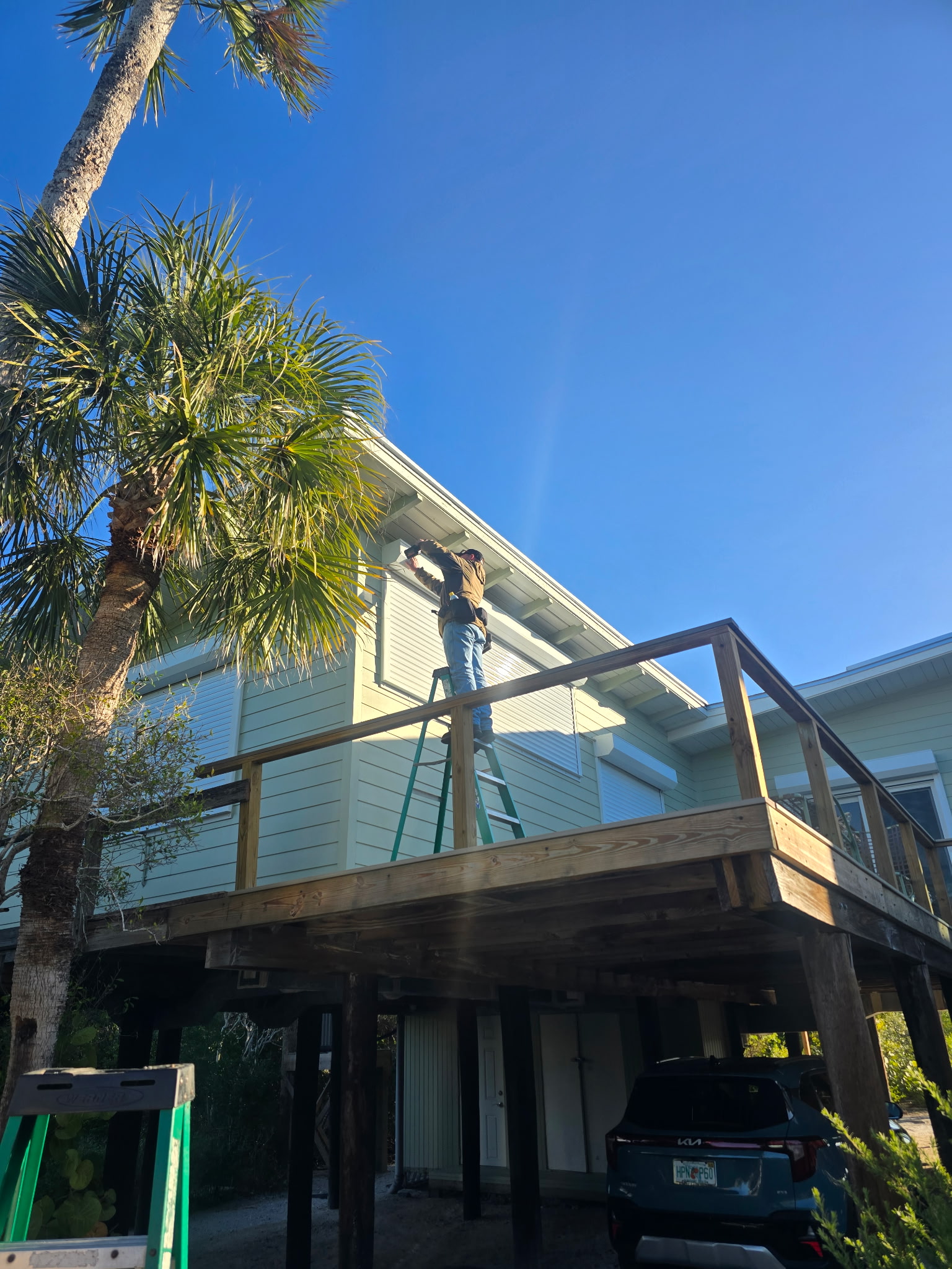 Technician servicing hurricane shutters on a Southwest Florida home